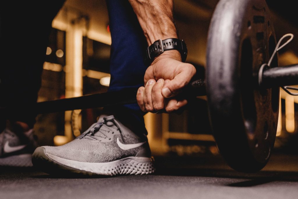 athlete gripping deadlift bar workout