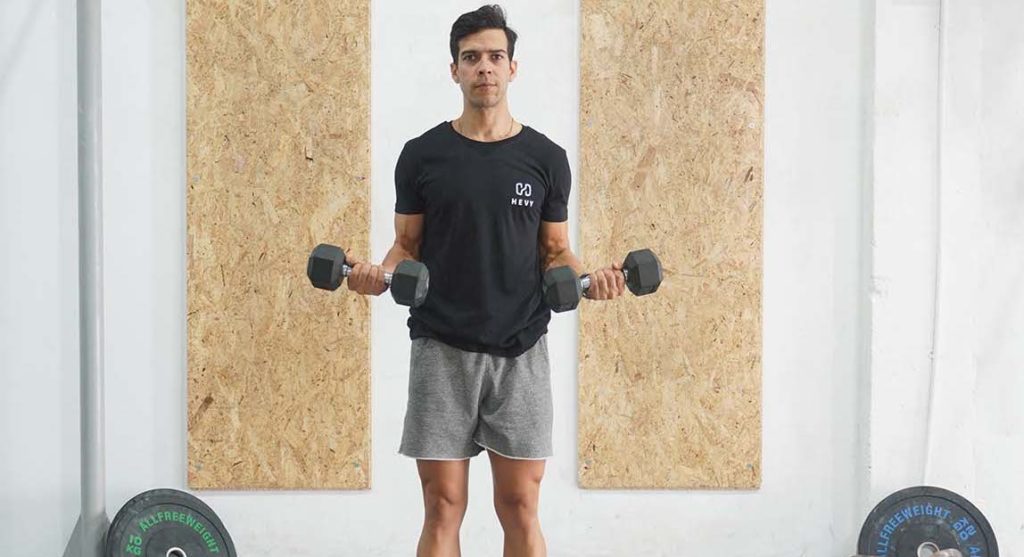 man bicep curl dumbbell Compound vs. Isolation Exercises