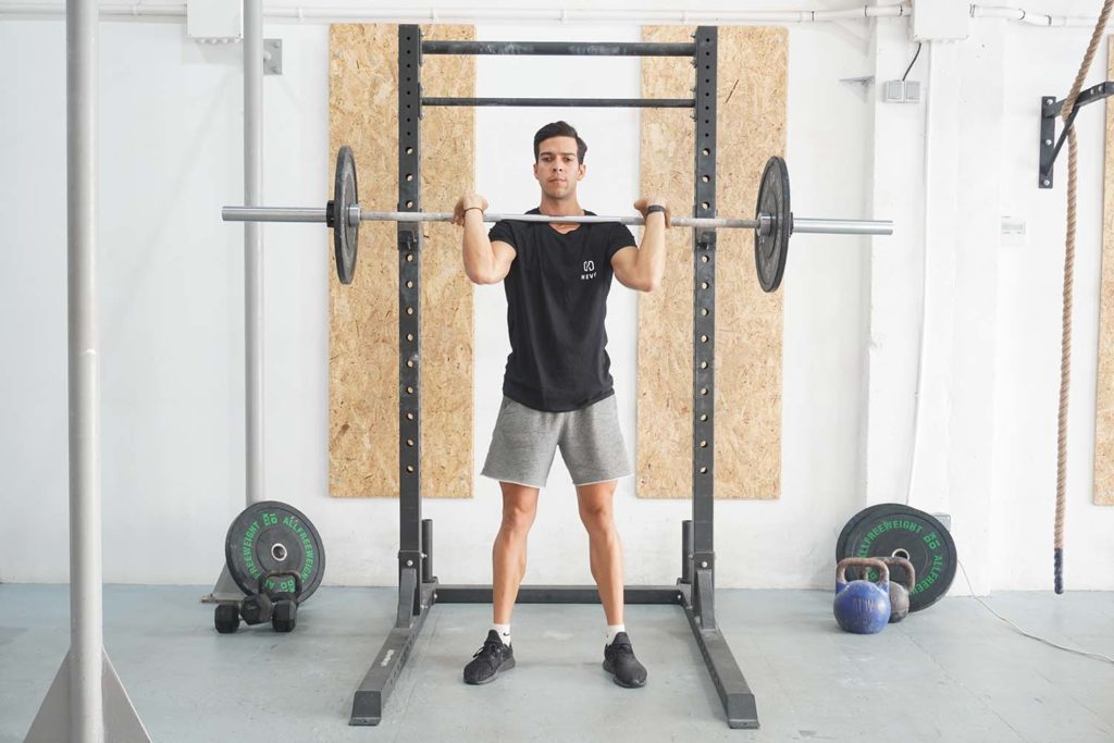 man standing full front squat barbell