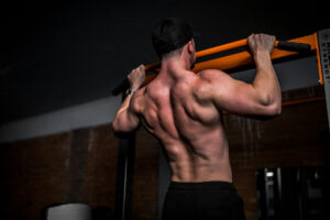 a man performing pull-ups at the gym